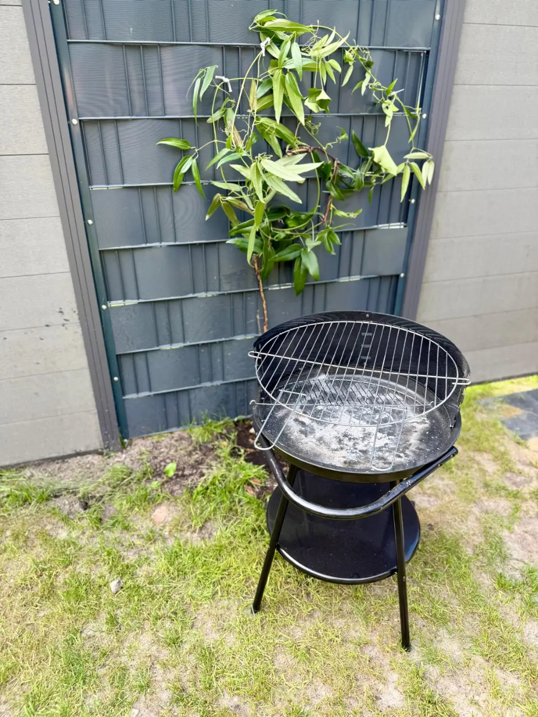 Holzkohlegrill an der Hauswand