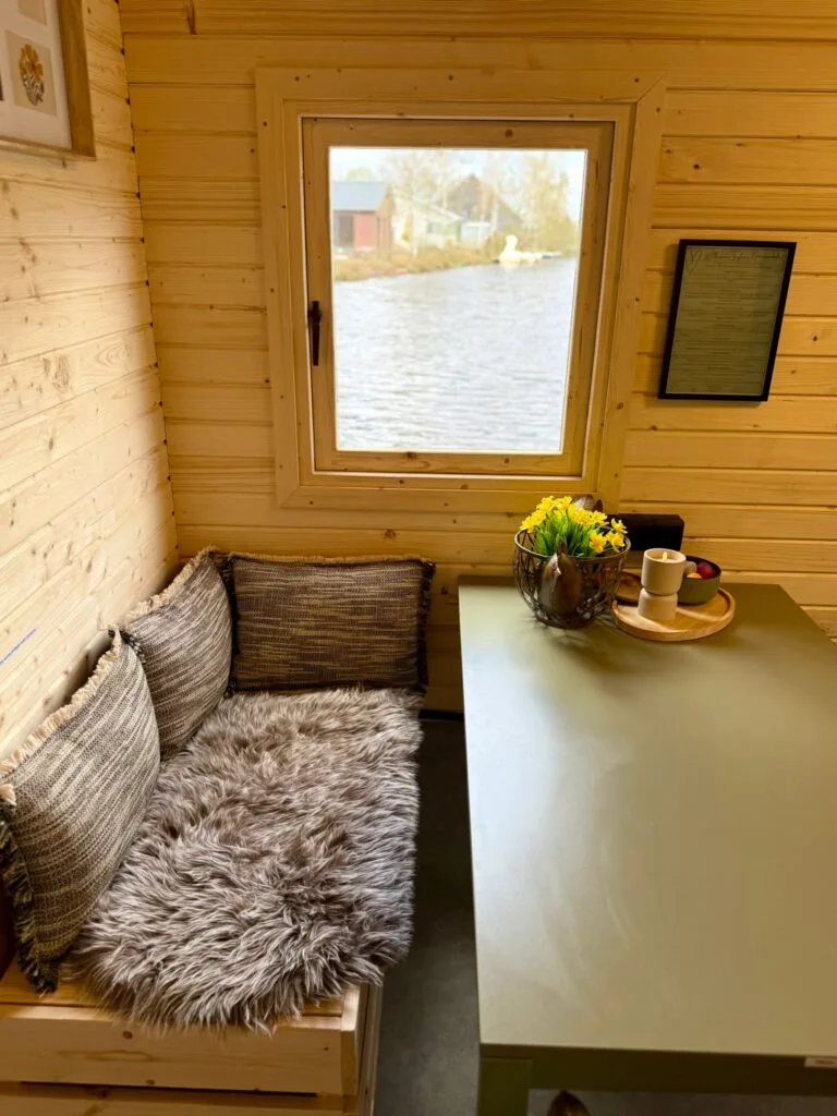 Sitzecke im Schlaffass mit Kissen, Blumen und Kaffee