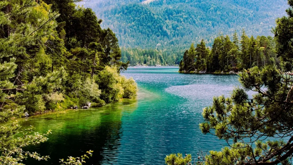 Türkisfarbener See vor bewaldeten Bergen